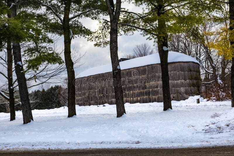 A reconstructed Haudenosaunee (Iroquois) longhouse built from wood and elm bark, illustrating how Indigenous peoples used forest resources for shelter.